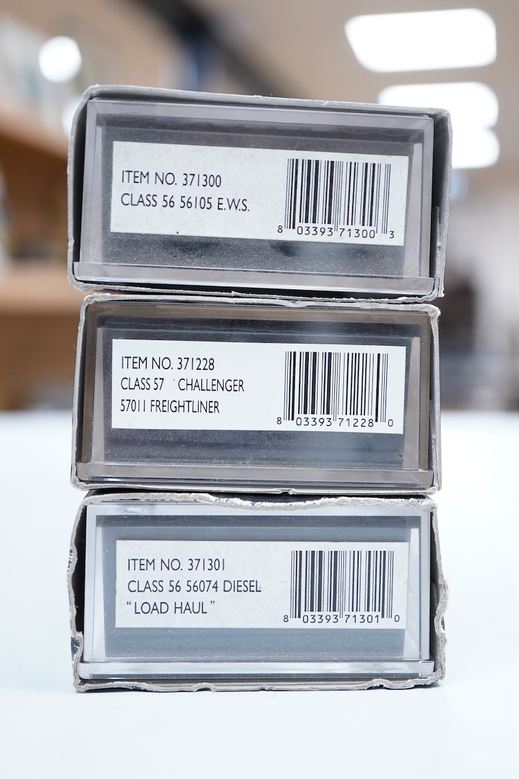 Three boxed Graham Farish N gauge railway diesel locomotives; an EWS class 56, 56105 (371300), a Load Haul class 56, Kellingley Colliery 56 074 (371301), and a Freightliner class 57, Freightliner Challenger 57011, (37122